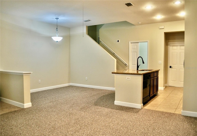 kitchen with light carpet, dark stone countertops, dishwasher, pendant lighting, and sink