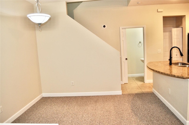 interior space featuring light colored carpet and sink