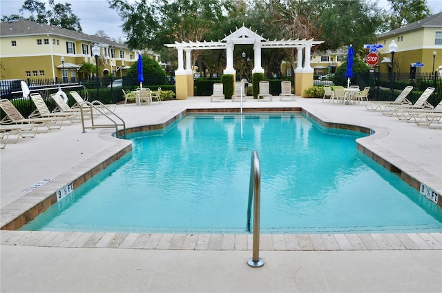 view of swimming pool with a patio area and a pergola