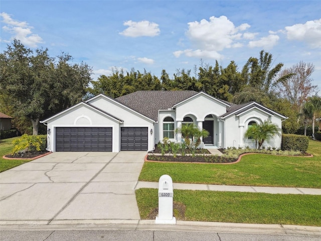 single story home with a front lawn and a garage