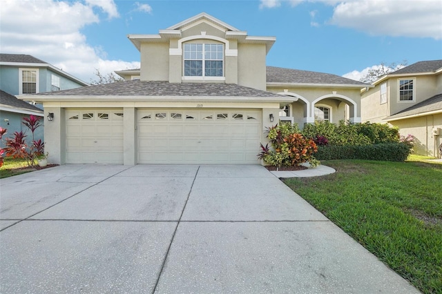 front of property with a front lawn and a garage