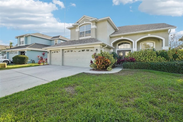 view of property featuring a front yard, french doors, and a garage