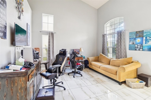 office area with a towering ceiling