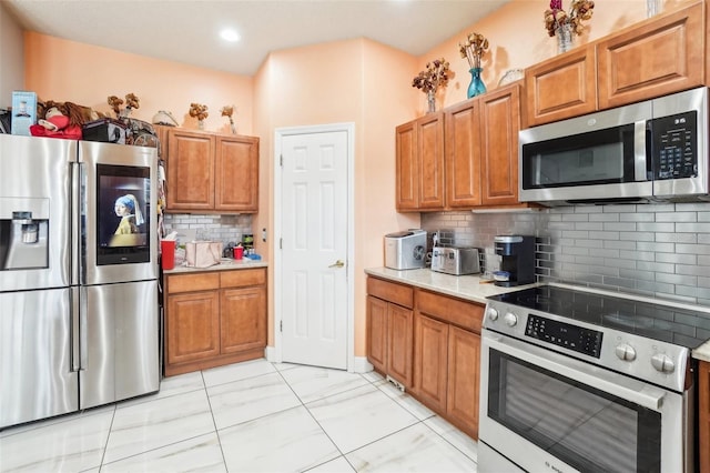 kitchen with decorative backsplash and appliances with stainless steel finishes