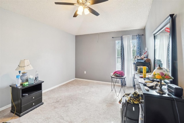 misc room with ceiling fan, light colored carpet, and a textured ceiling