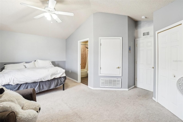 carpeted bedroom with ceiling fan, connected bathroom, a textured ceiling, and vaulted ceiling