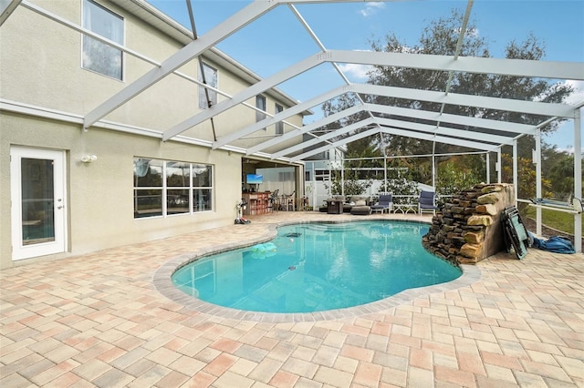 view of pool featuring a lanai and a patio