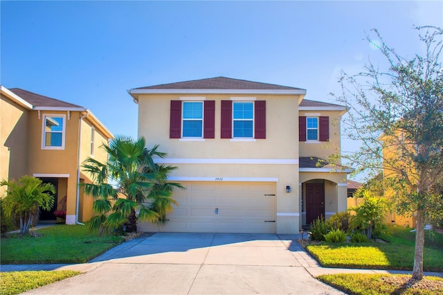 view of front property featuring a garage and a front yard