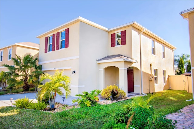 view of front of property with a garage and a front lawn