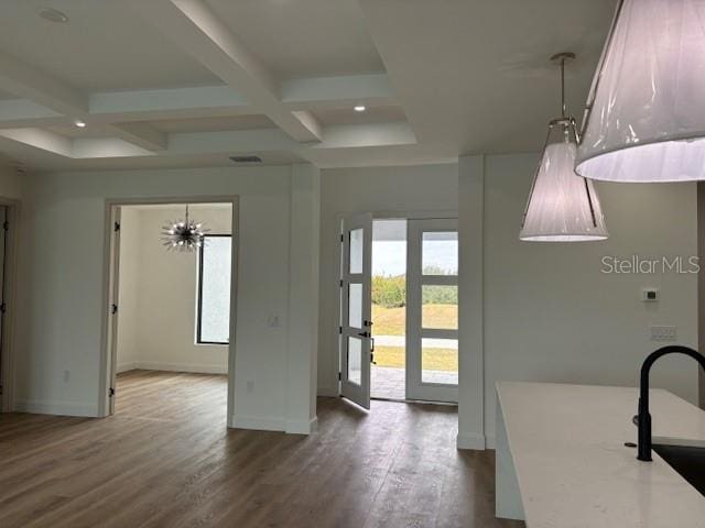 interior space featuring sink, coffered ceiling, a wealth of natural light, and beam ceiling