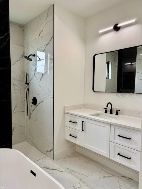 bathroom with shower with separate bathtub and vanity