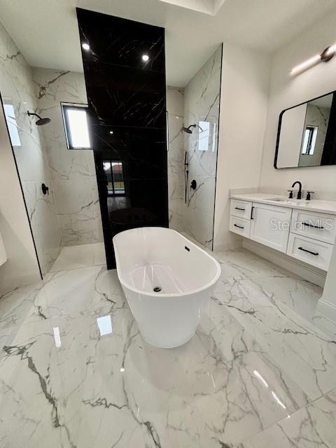 bathroom featuring vanity and shower with separate bathtub