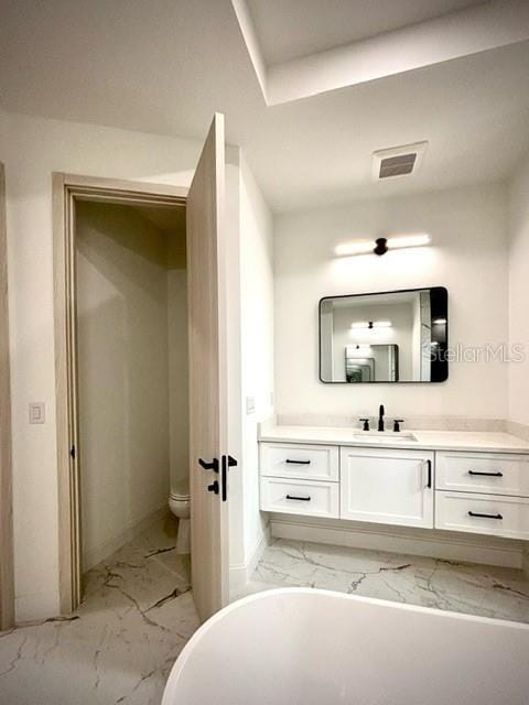 bathroom featuring toilet and vanity