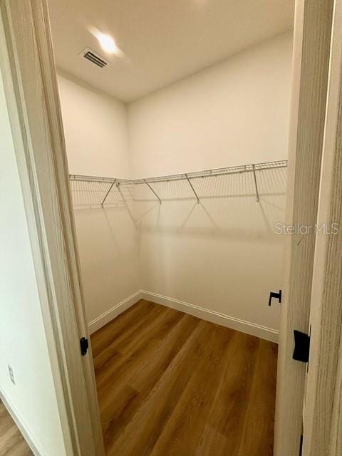 walk in closet featuring hardwood / wood-style floors