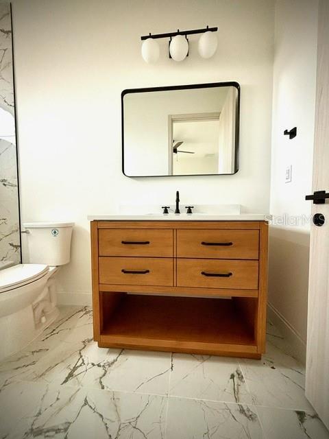 bathroom with toilet and vanity