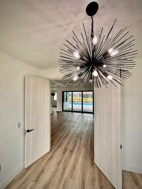 interior space featuring hardwood / wood-style floors and a notable chandelier