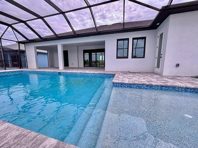 view of pool with a lanai and a patio area