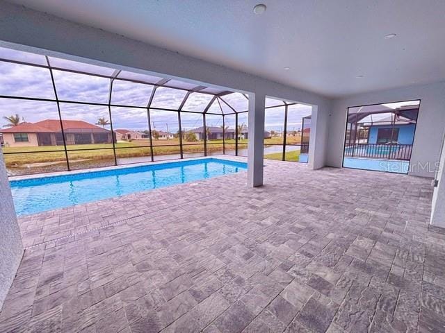 view of pool featuring a lanai and a patio