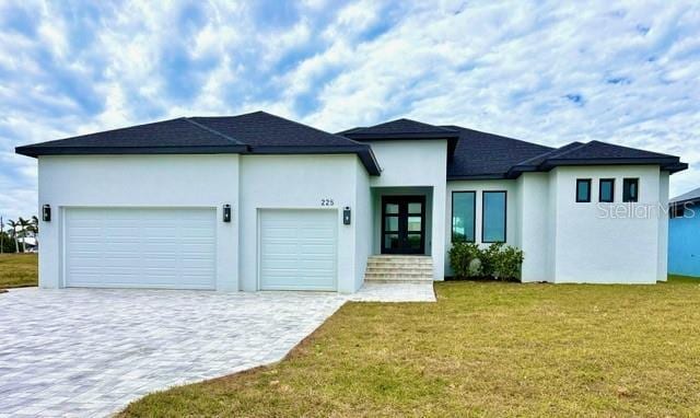 view of front of property featuring a front lawn and a garage