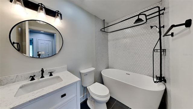 bathroom with toilet, a bath, tile patterned floors, and vanity