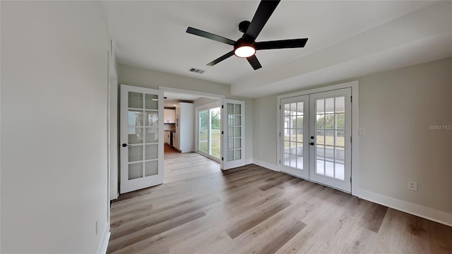 spare room featuring ceiling fan, light hardwood / wood-style flooring, and french doors