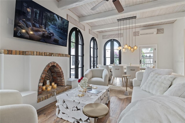 living room featuring hardwood / wood-style floors, wooden ceiling, an AC wall unit, beam ceiling, and ceiling fan with notable chandelier