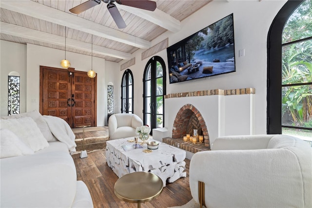 living room with dark hardwood / wood-style flooring, ceiling fan, wood ceiling, and beam ceiling