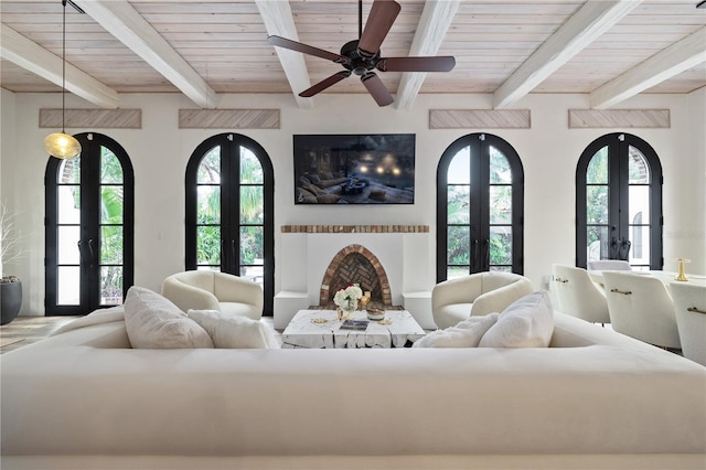 living room featuring ceiling fan, beam ceiling, french doors, and wood ceiling