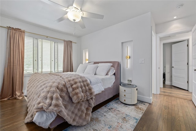 bedroom with wood-type flooring and ceiling fan