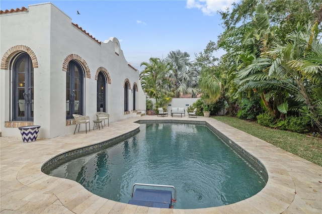 view of pool with a patio and french doors