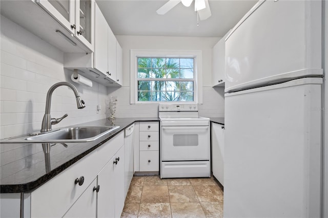 kitchen featuring white appliances, white cabinetry, backsplash, and sink