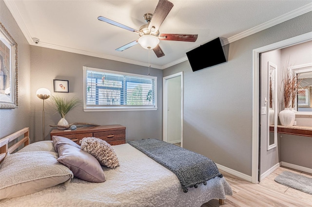 bedroom featuring ceiling fan, light wood-type flooring, and ornamental molding