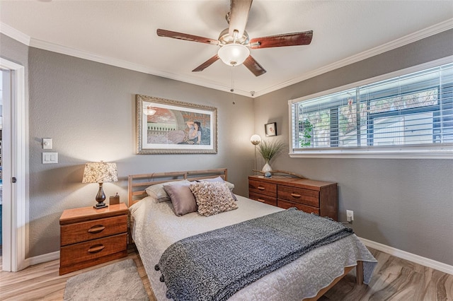 bedroom featuring ceiling fan, light hardwood / wood-style flooring, and crown molding