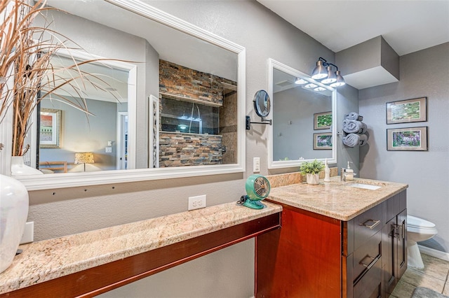 bathroom featuring toilet, tile patterned floors, and vanity