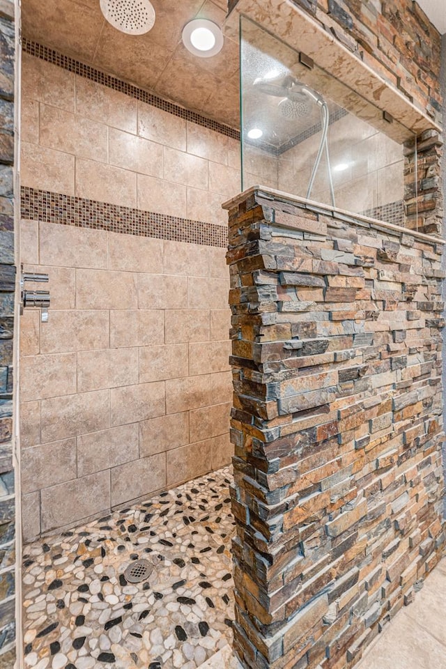 bathroom with tiled shower