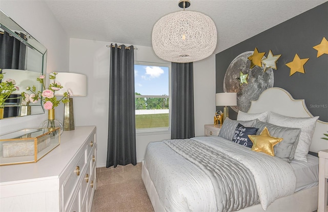 bedroom featuring light carpet and a textured ceiling