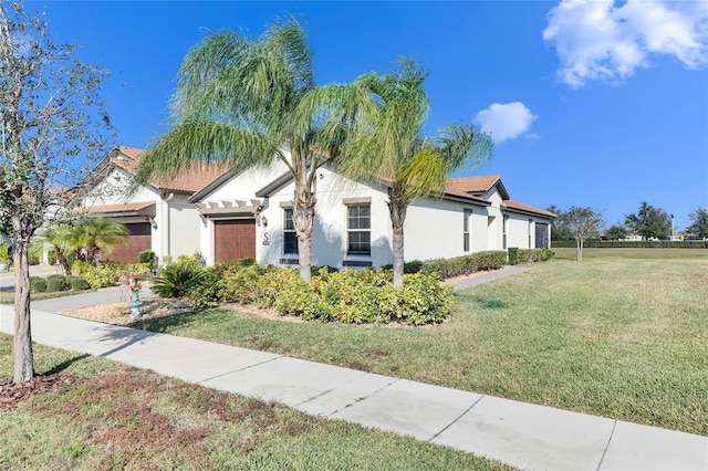 view of front of home with a front yard and a garage