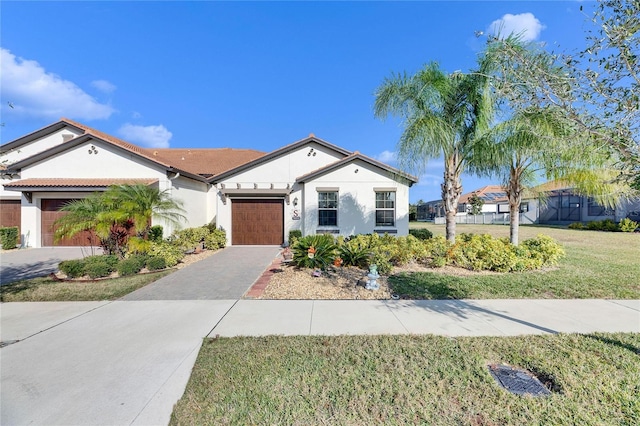 view of front of house featuring a front yard and a garage