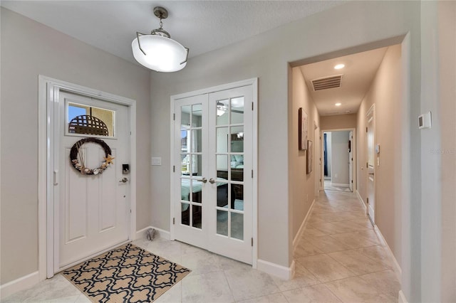 tiled foyer entrance with french doors