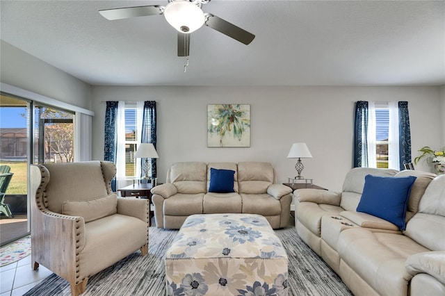 tiled living room with a textured ceiling and ceiling fan