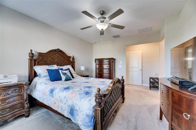 carpeted bedroom with a textured ceiling and ceiling fan