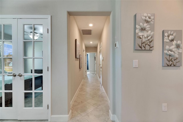 hall featuring french doors and light tile patterned flooring