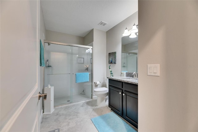 bathroom featuring a textured ceiling, tile patterned flooring, toilet, an enclosed shower, and vanity