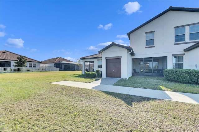 view of front of home featuring a front yard and a garage