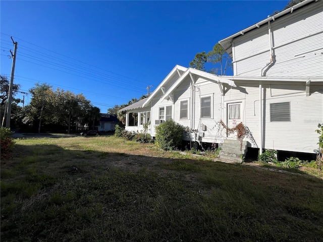 view of property exterior with a yard