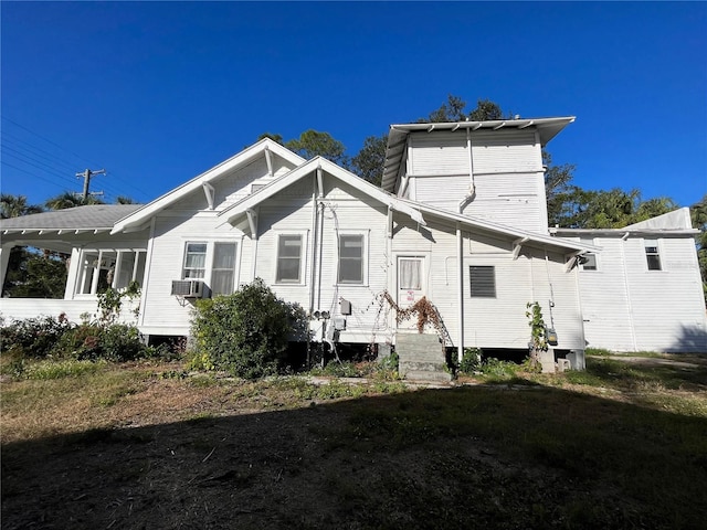 rear view of house featuring cooling unit