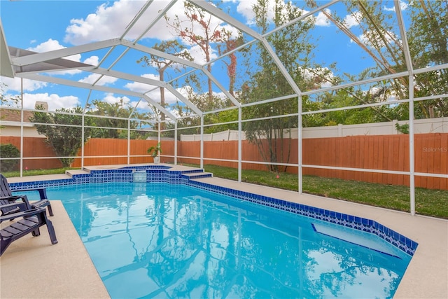 view of swimming pool featuring a patio and glass enclosure