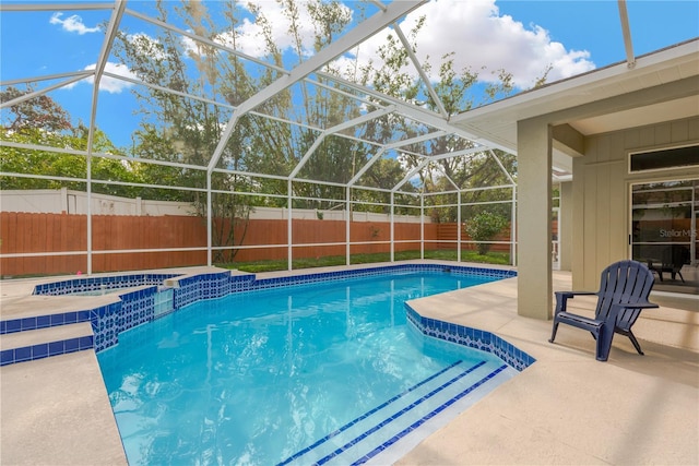 view of swimming pool with glass enclosure and a patio