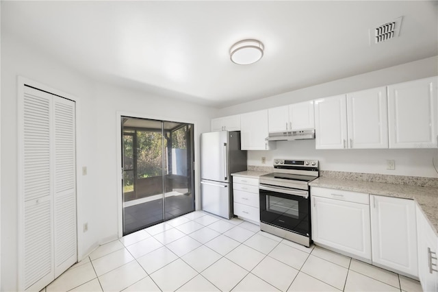 kitchen with light stone countertops, white cabinetry, appliances with stainless steel finishes, and light tile patterned flooring