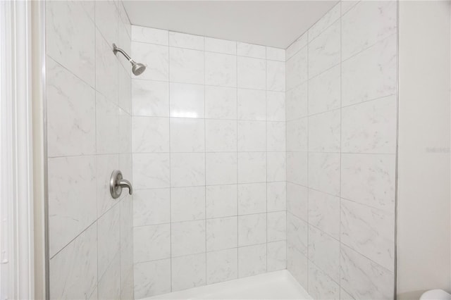 bathroom with tiled shower